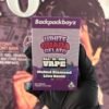 WHITE GUAVA GELATO 1 Hands in black gloves hold a purple Backpackboyz All-in-One Vape box labeled 'White Guava Gelato'